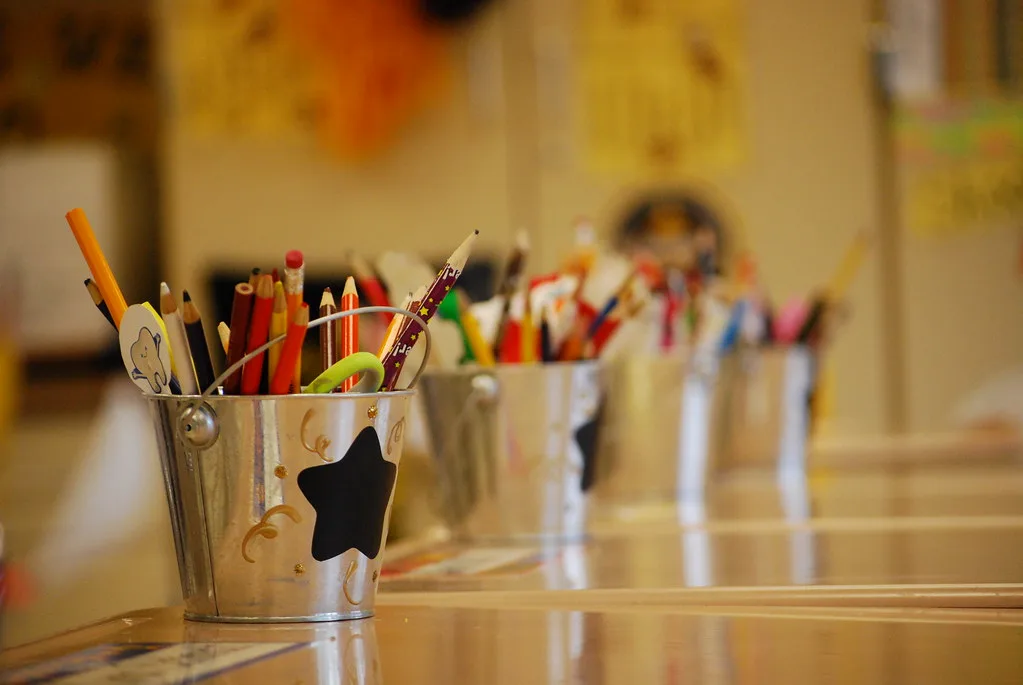 Notebooks, pens and school supplies on a desk — back-to-school budget planner for US families