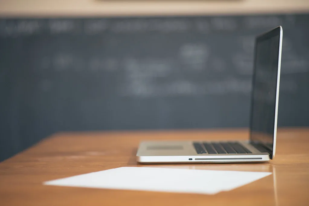 Working online on a laptop with a coffee — How to Avoid Online Earning Scams in 2026