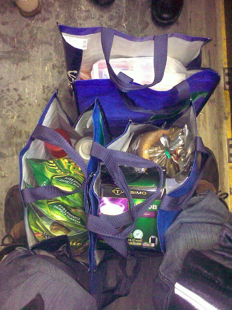 Groceries and fresh food in a shopping cart — 17 Genius Ways Students Can Save Money on Groceries