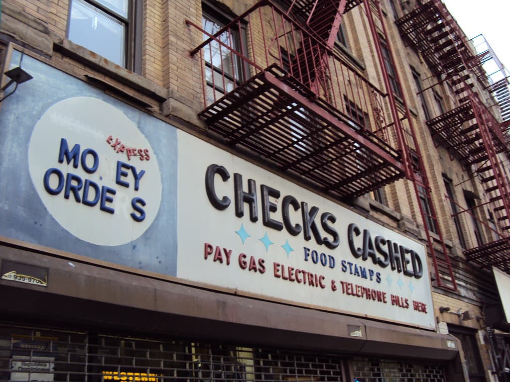 Paying bills and managing money at a desk — 50 Ways to Pay Off Debt Faster