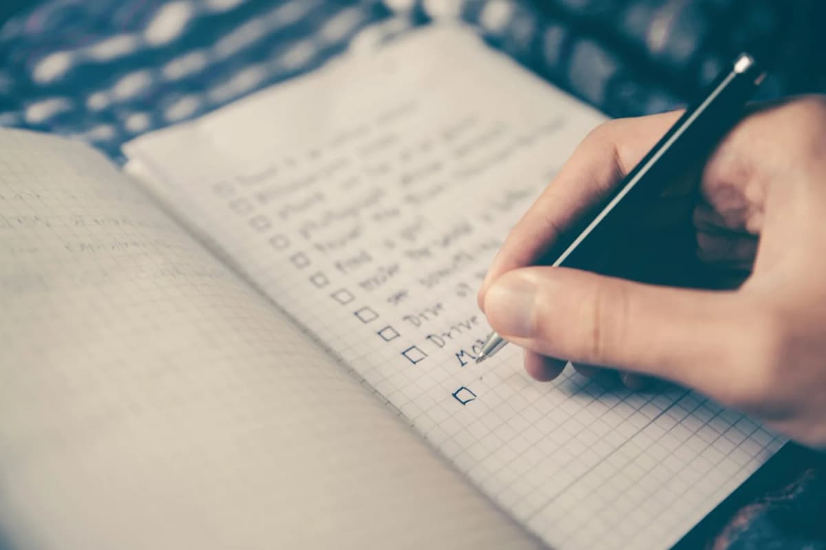 50/30/20 Budget Calculator — A notebook, pen, and coffee for planning