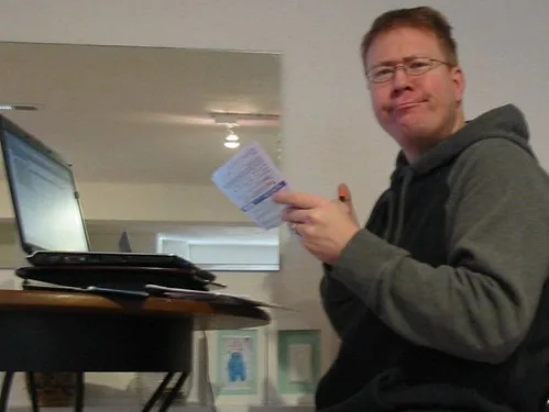Paying bills and managing money at a desk β Dave Ramsey Baby Steps Explained: Does It Work in 2026?