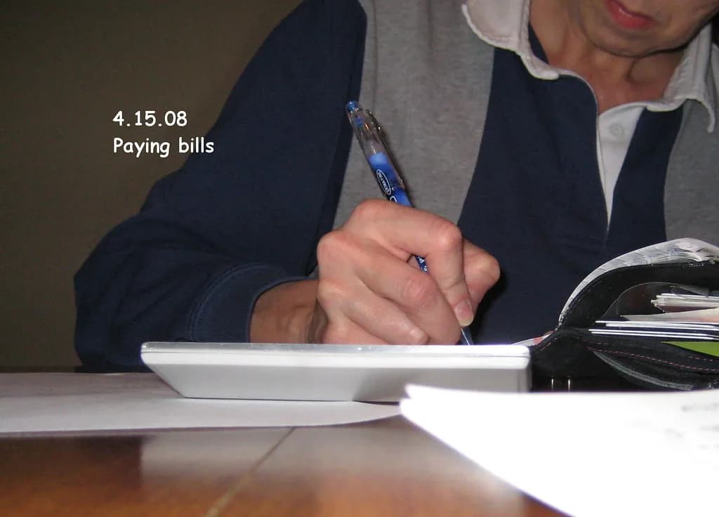 Paying bills and managing money at a desk β paying off $10,000 of debt in 12 months